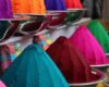 Brightly colored pigment powders displayed in metal bowls and cones